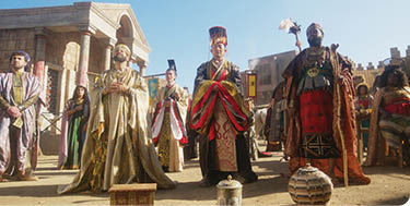 A group of people dressed in costumes and holding staffs stand in front of a building. AI generated content