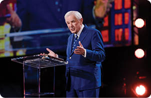 A man in a suit stands at a podium, giving a speech. AI generated content