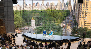 Two men are on stage in front of a large audience. AI generated content