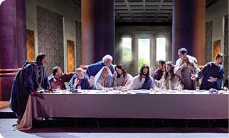 A group of people are gathered around a large dining table, with some sitting and others standing. The table is set with plates, bowls, and cups, and there are wine glasses placed around the table. The scene appears to be a formal gathering or a celebration, with the people dressed in formal attire. AI generated content