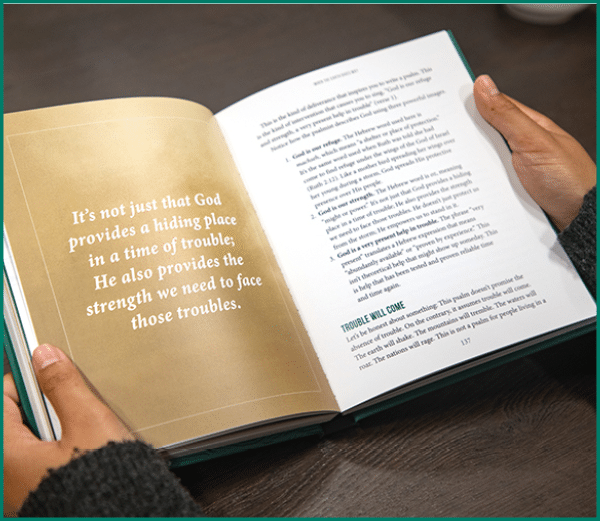 A person is holding a book open to a page with a quote about not being content with just being comfortable. AI generated content